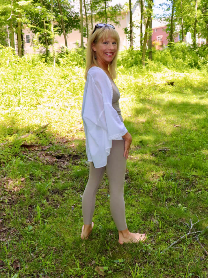 Regan standing in field looking back at camera and smiling