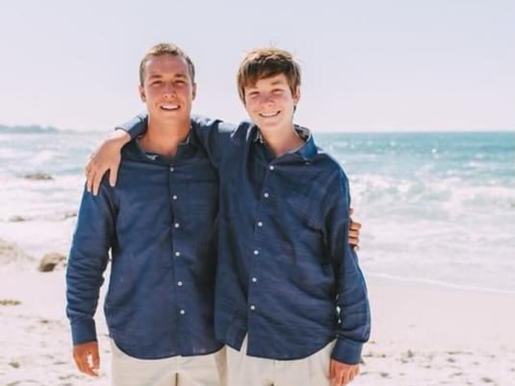 Regan's sons standing on beach