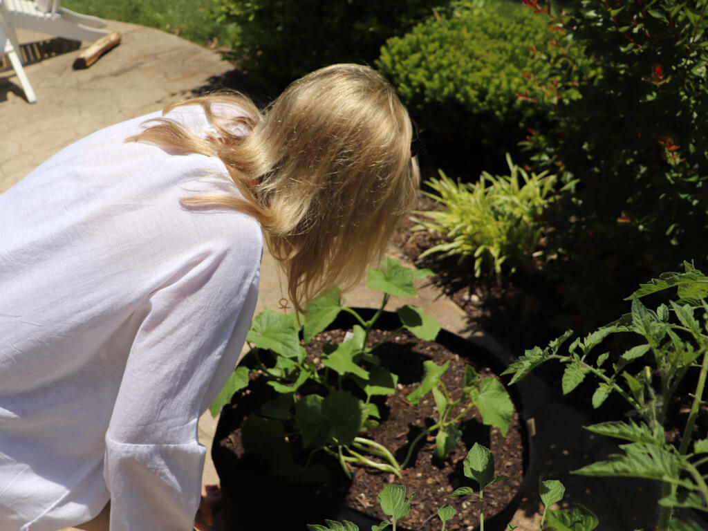 Regan inspecting potted plants